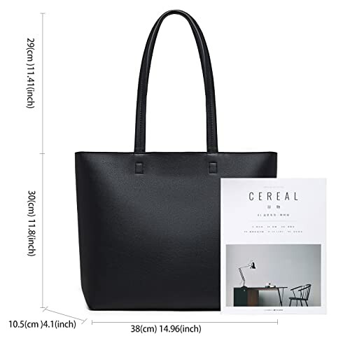 Black tote bag next to a magazine with dimensions displayed.