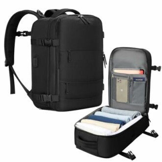 Black travel backpack with open compartment showing organized clothes and pockets.