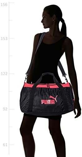 Person carrying a Puma duffel bag