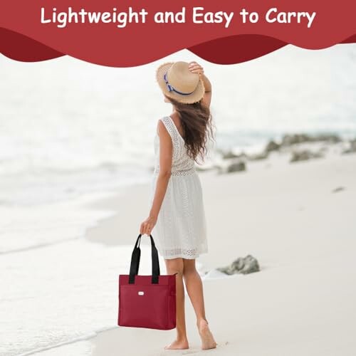 Woman on beach carrying a red tote bag