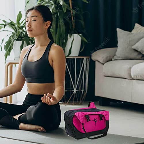 Woman meditating on a yoga mat with a gym bag nearby.